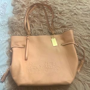 Like new Coach purse. Peach with being interior. 3 inside pockets.